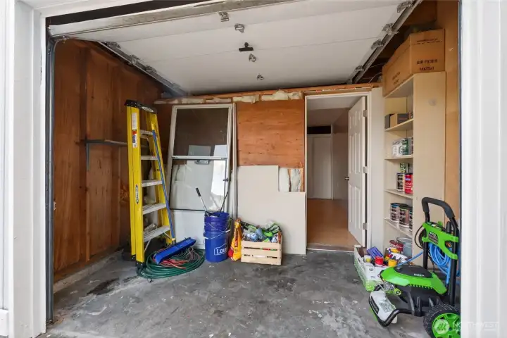 This is the front of the former garage, still accessible with the garage door.  A great space for a hobbyist or to store bikes, and tools.