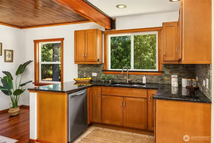 The kitchen hosts new appliances, black granite countertops, custom cherry cabinetry The kitchen hosts new appliances, black granite countertops, custom cherry cabinetry