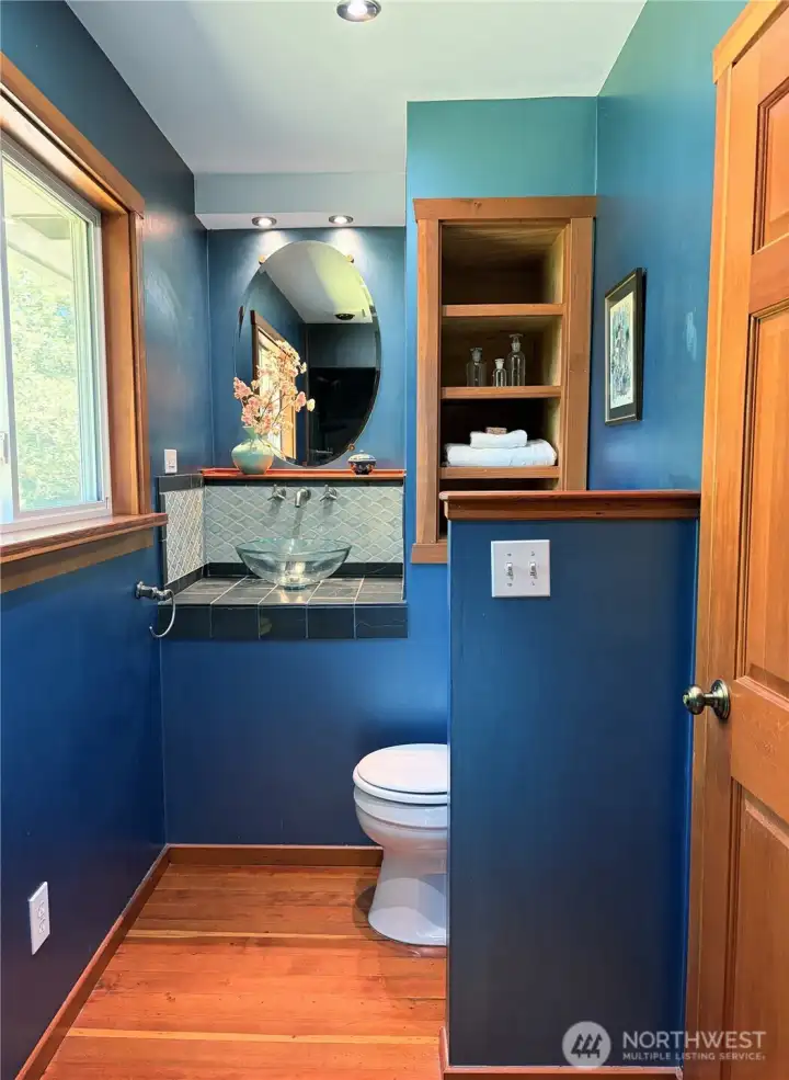 The main-level bath is beautifully done, featuring a black slate walk-in shower with a pebble floor and designer fixtures The main-level bath is beautifully done, featuring a black slate walk-in shower with a pebble floor and designer fixtures