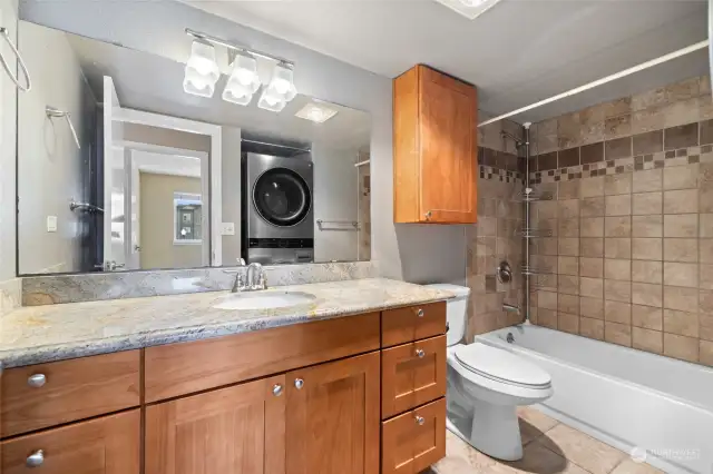 Remodeled bathroom showing new washer/dryer in the mirror.