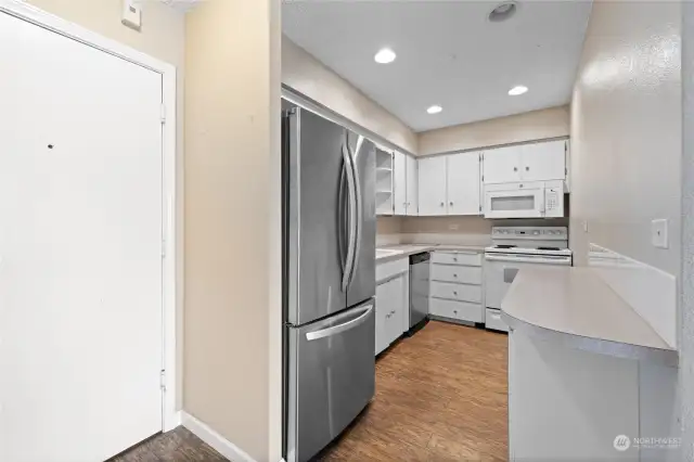 Entry door to the left  leads into kitchen with nearly all new appliances, including water heater hidden under corner of the countertops.