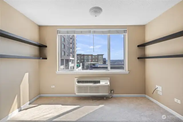 Living room with heating/air conditioning system.