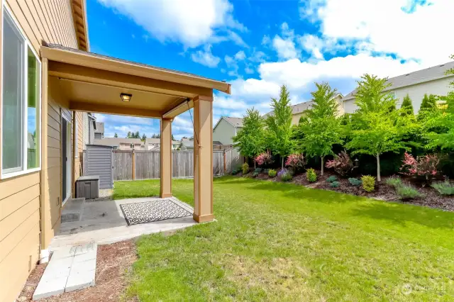 Covered patio, storage shed and absolutely gorgeous professional landscaping to take advantage of the beauty and privacy in your beautiful yard.