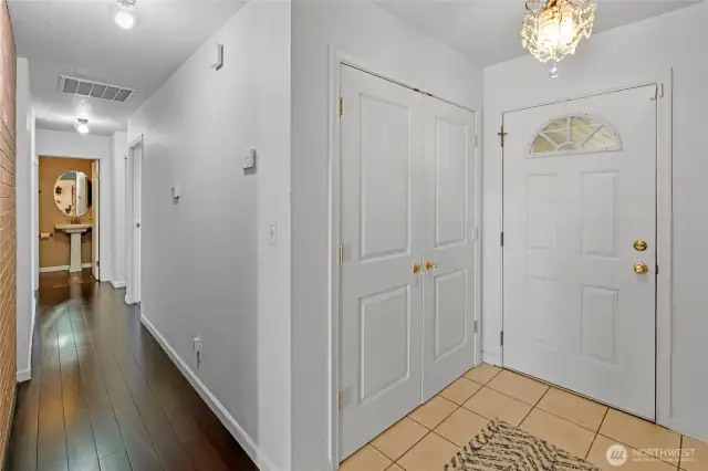 Main level hall leading to the bedrooms. The guest bath has since been painted white.
