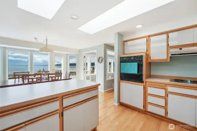 The large kitchen is open to the views and perfect for entertaining with the open concept dining room and access to the outside patio.