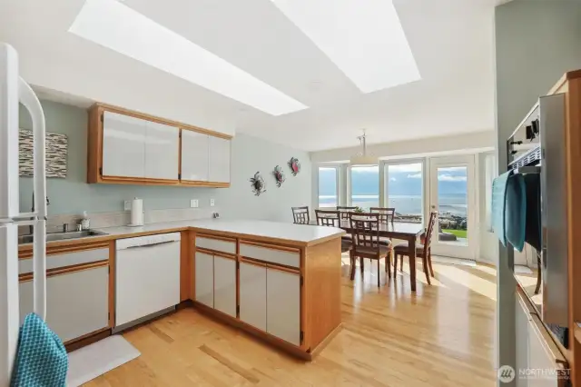 The large kitchen is open to the views and perfect for entertaining with the open concept dining room and access to the outside patio.