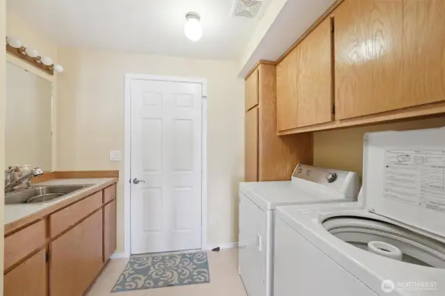 Laundry room and extra bathroom space with shower.  Rinse off after a day at the beach.