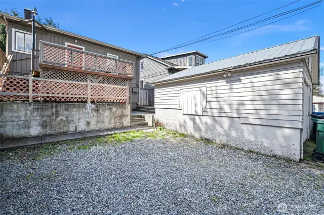 gravel ally parking next to detached garage