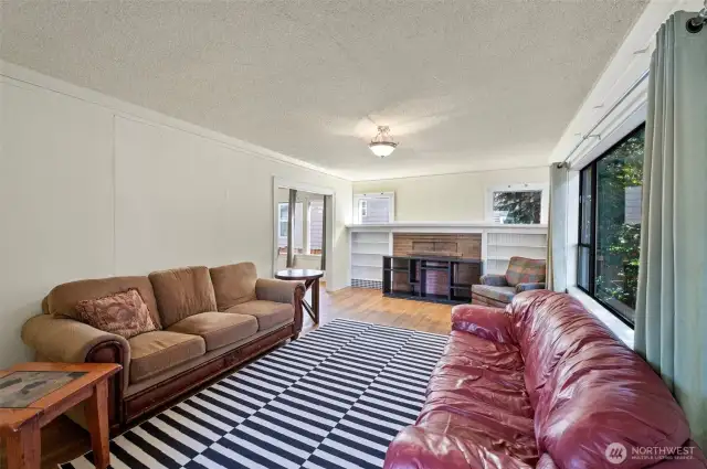 living room with brick wood burning fireplace