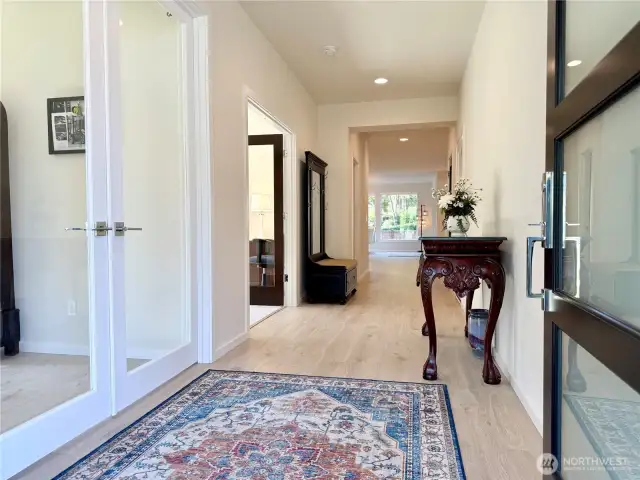 View of the entry inside. 1st doors on the left is the office/den. 2nd doors on left is finished bonus room. 3rd door is the half bathroom.