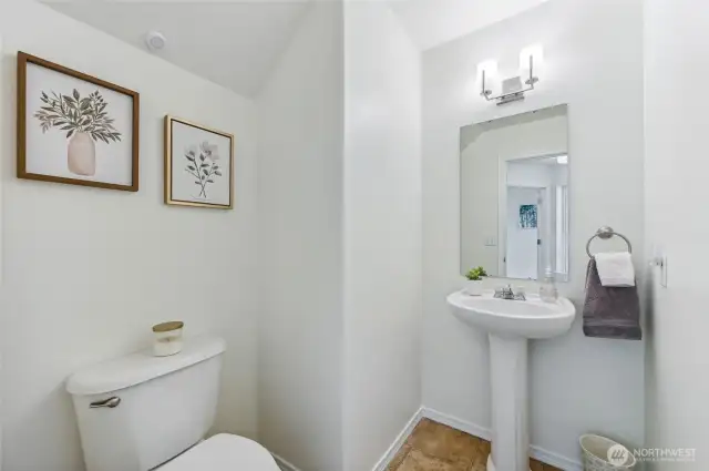 Powder room on main floor is sizeable and very chic.