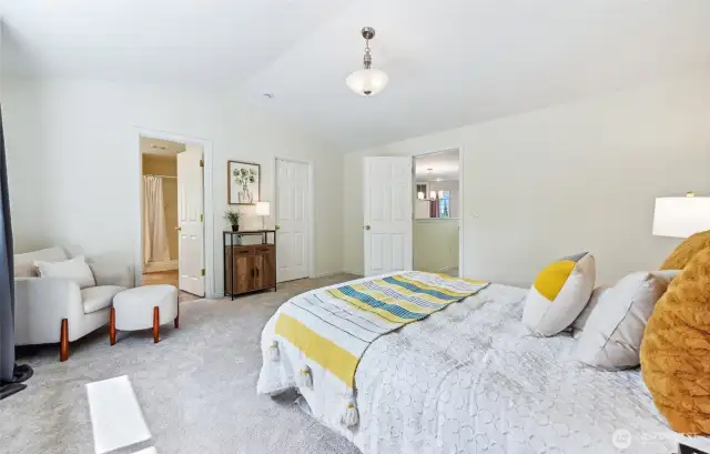 Primary bedroom opens to en-suite bathroom and walk-in closet.