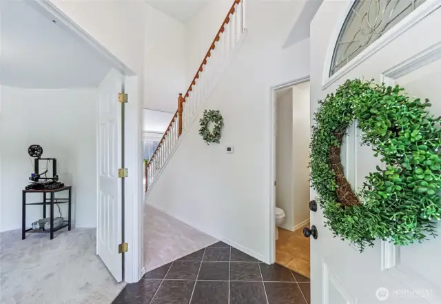 Step inside to the foyer with high, vaulted ceilings. Office space to the left is perfect for work at home days.