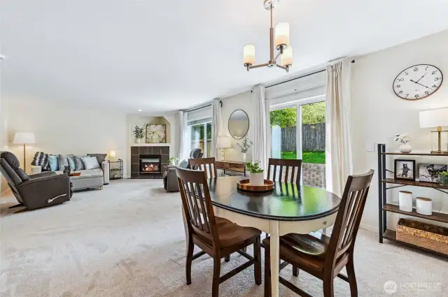 Dining area opens to living space and has slider that leads to the private backyard.