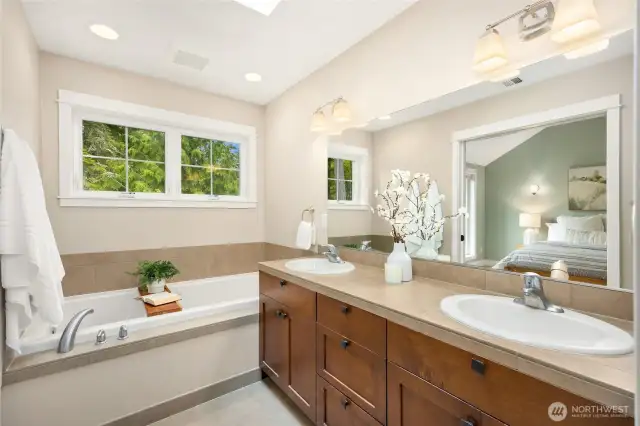 Enjoy a spa-like feel in the primary bath with double vanity, soaking tub, and separate shower.