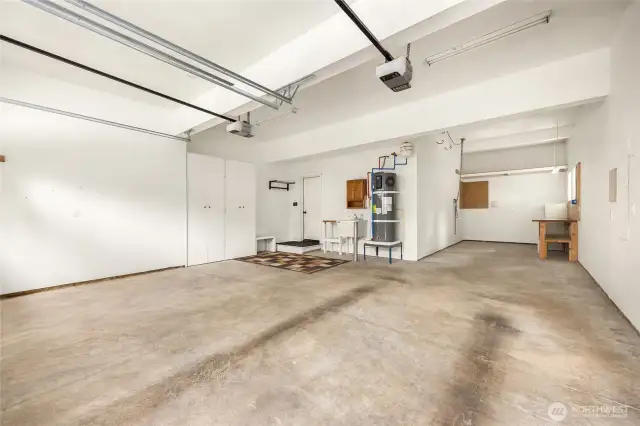 Tandem third bay currently functions as a workshop space with room for hobbies or projects.