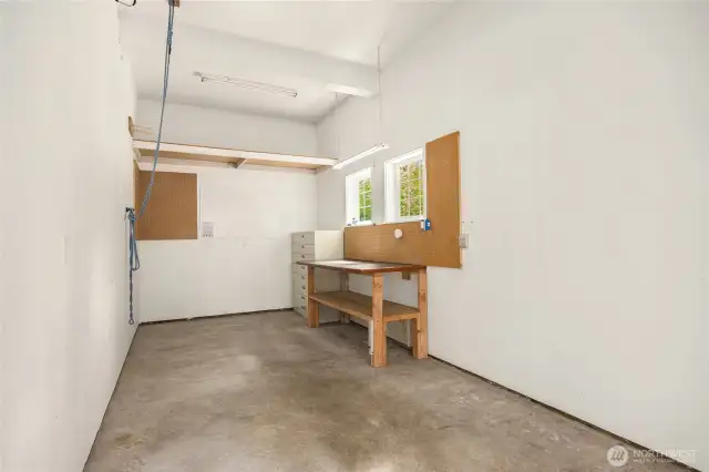 Pulley system for kayak storage and a workbench setup make this garage ready for adventure.