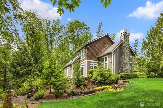 Gently sloping side yard is full of potential—expand your garden or enjoy as-is.