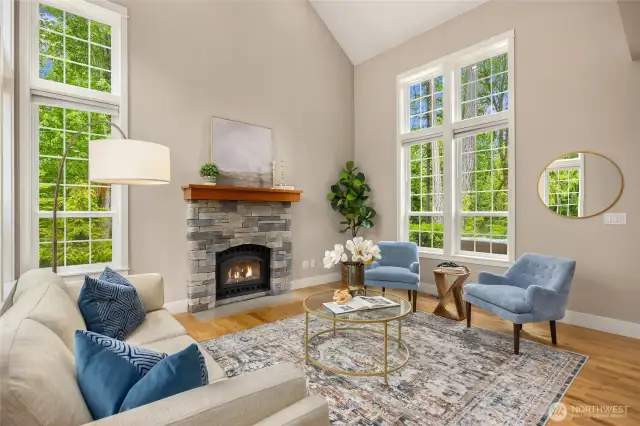 The light-filled living room centers around a cozy wood-burning fireplace—perfect for Northwest evenings.