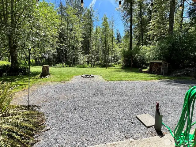 Looking from the shelter past the water spigot over the firepit towards No Name Creek
