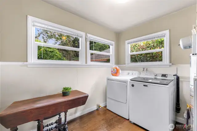 Spacious laundry/utility room has lots of windows for great lighting and a back door to the deck and garage