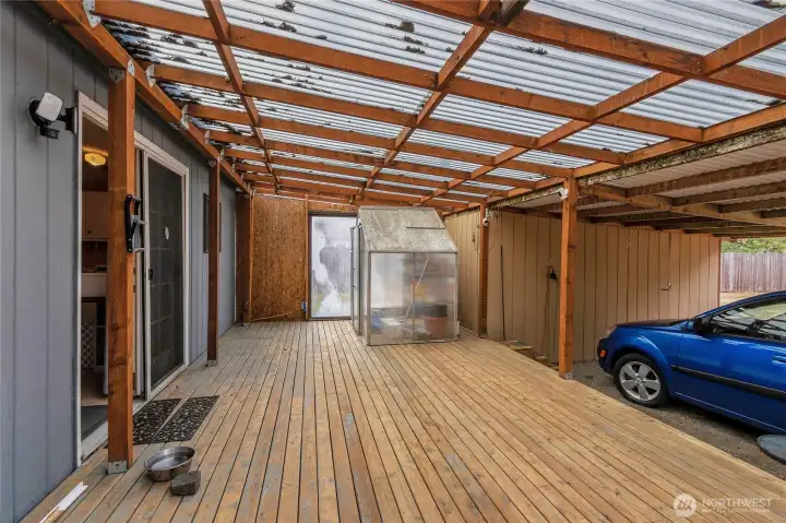 Large covered back deck with covered carport and tool shed