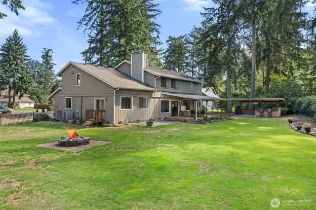 Huge yard with firepit, covered firewood area and lots of room to play.