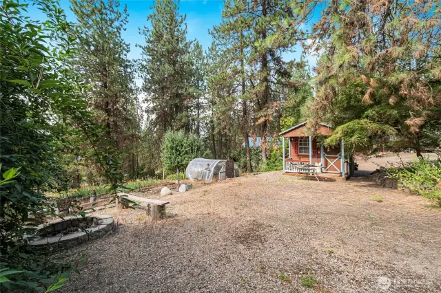 Backyard with fire pit, garden area and insulated garden shed with power
