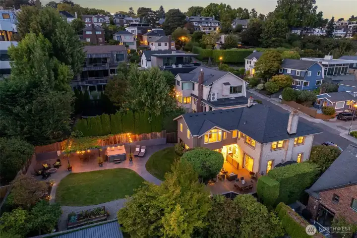The house is much larger than it appears from the street- the addition on the back created a large family room extension off the kitchen, and the Primary suite above.  It also creates an "L" shape that wraps around the back patio so that the patio can be accessed from the living room french doors or from the family room/kitchen area- perfect for entertaining and outdoor dining!