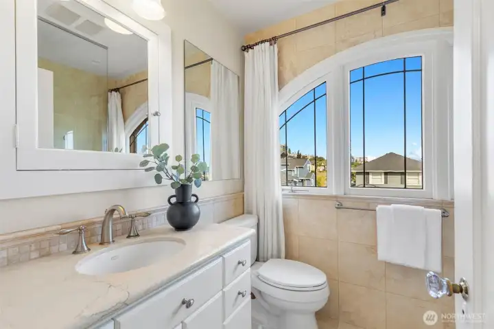 The upstairs hall bath has been remodeled and features a stone tile walk in shower.