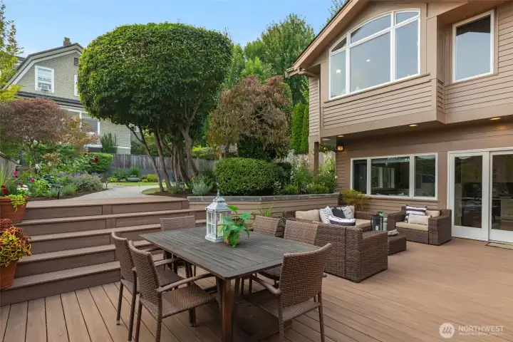 The back patio can be accessed from either the living room or family room.  It's facing SW so gets great sun.  It's plumbed for gas for the grill and is ready to host!  All of the planter beds and pots have watering systems built in, and there is power out here as well.