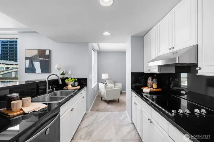 Gourmet kitchen featuring sleek black granite and updated appliances. Perfect for urban living in downtown Bellevue.