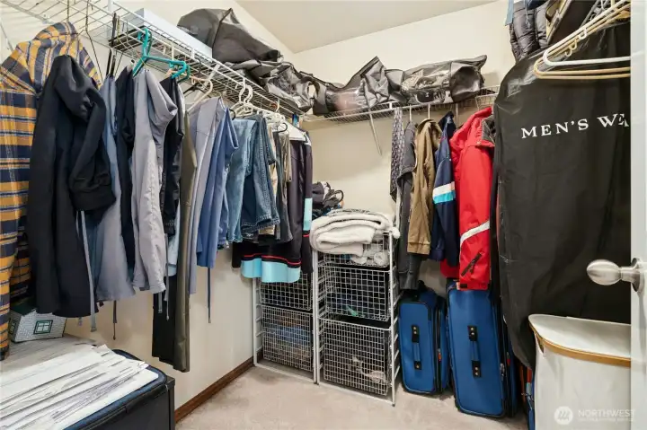 Primary suite includes a well-sized walk-in closet with abundant hanging and storage space.