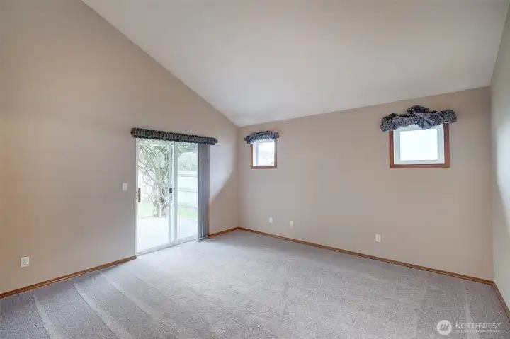 Primary bedroom with en-suite bath, walk in closet and glass sliding door to the patio.