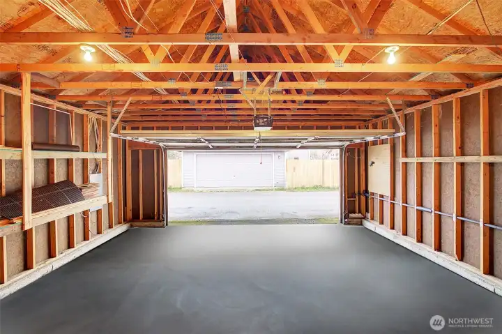 2 car Garage with built-in shelving and work bench with pegboard out of shot behind camera. (enhanced photo floor was wet and had reflective sheen removed)