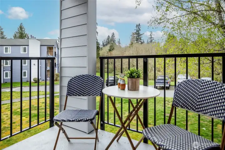 Private balcony opens onto lush greenspace.