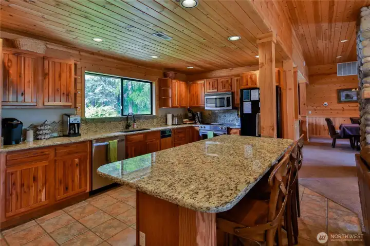 Ample countertops, cabinetry, and a large island with bar seating—ideal for entertaining and group gatherings