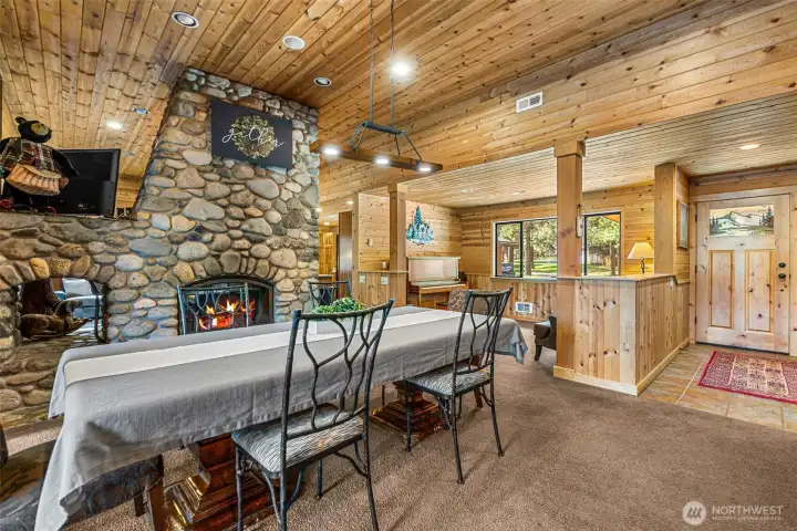 Spacious dining area with rustic wood finishes, statement chandelier, and seamless connection to the living spaces.