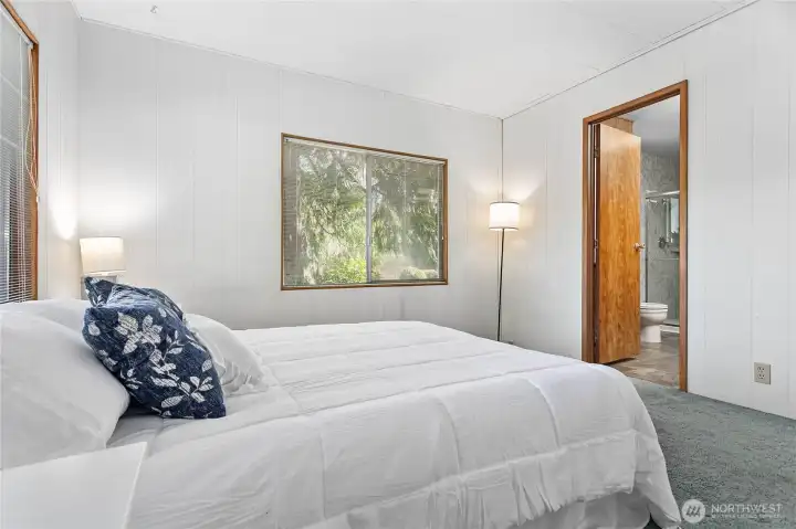 Primary bedroom with door to primary bathroom