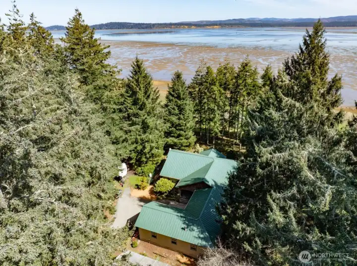 Nestled amongst the trees, this beautiful home with bayviews.