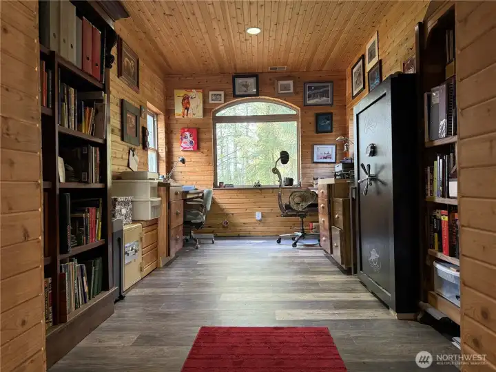 Between the kitchen and the two-car garage is the office with a forest view.