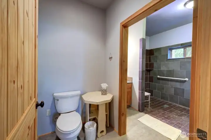 3/4 bath with water closet and beyond a huge walk in shower.