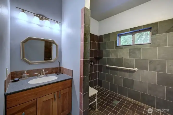 Custom cabinetry with the stone shower.