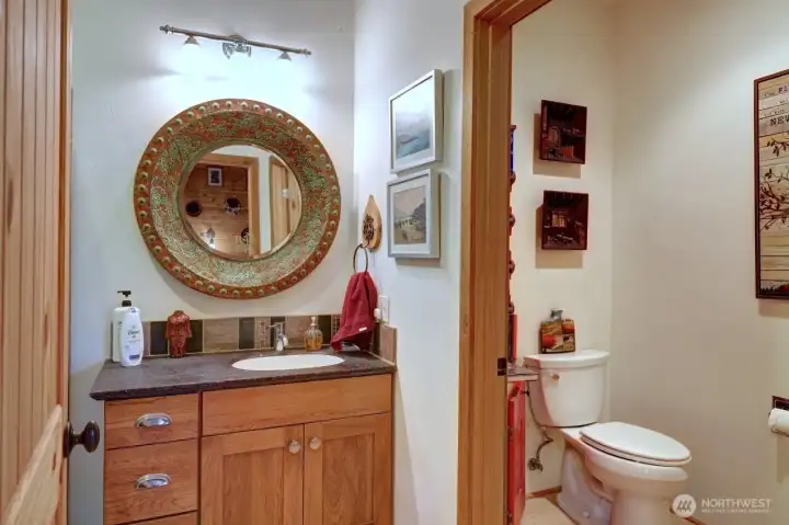 3/4 bath with a water closet and custom cabinets on the outside.