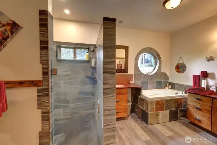 A better look at the tile shower with room for two. Soaking tub and other sink and cabinets.