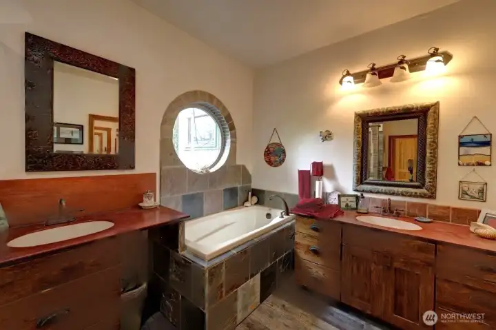 Note the unique window above the soaking tub, wrapped in stone.