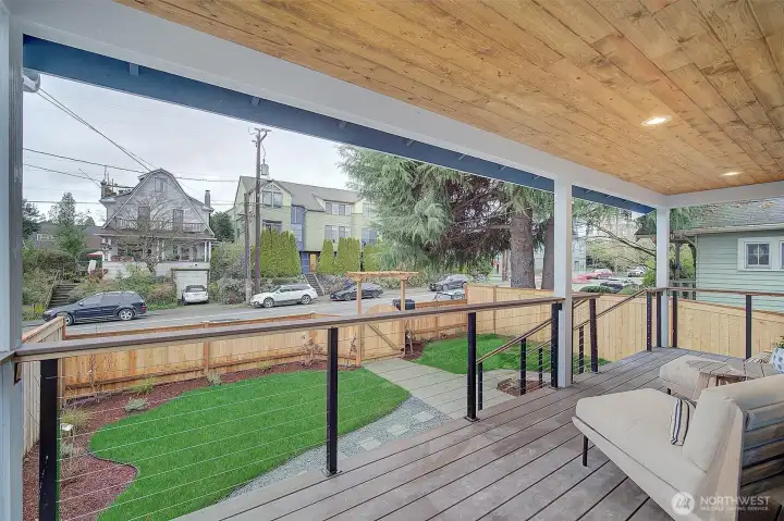 Beautiful large front porch looking out over the fenced front yard.