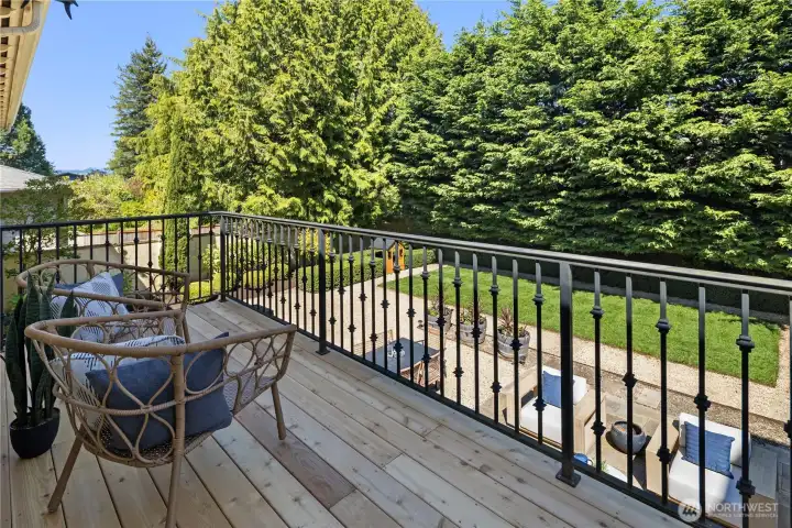 A private deck set above the grounds, with opportunity to incorporate a staircase for seamless connection to the expansive outdoor space below.