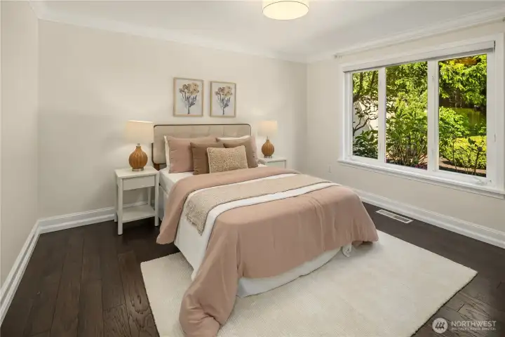 Light-filled bedroom No 3 with soft tones and garden outlooks.