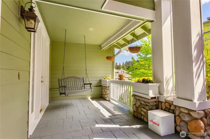 Charming covered front porch with swing